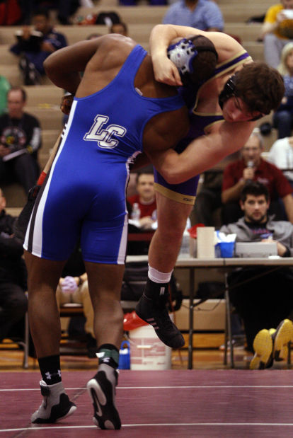Lake Central's Gelen Robinson lifts Hobart's Jon Ramirez off of his feet during Saturday's semifinals of the Lake County Championships.